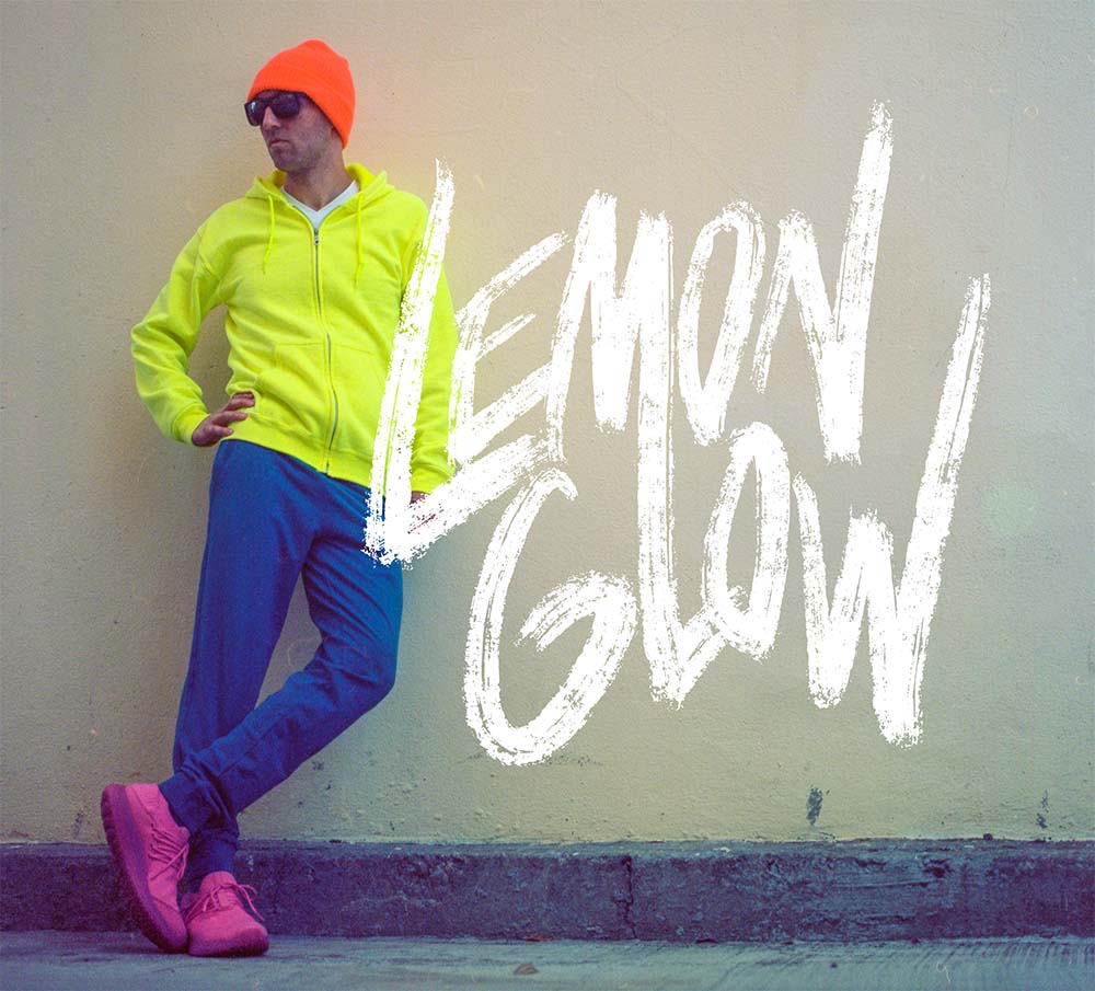 portrait of Marc against a white wal wearing neon, with lemonglow word mark overlaid